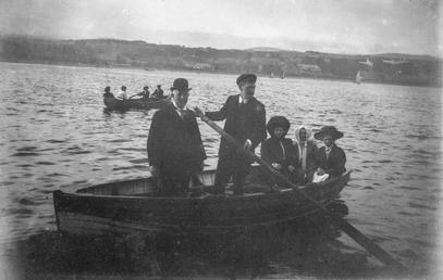 Group pictured in a rowing boat, Douglas Bay