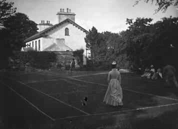 Tennis court scene with people on court