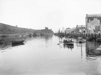 Peel harbour looking towards Peel Castle with rowboat…