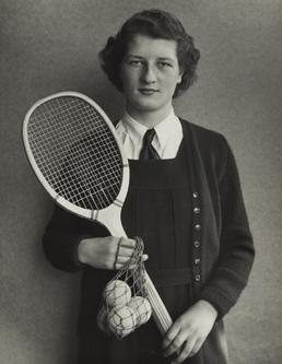 Christine Holgate, standing holding tennis racquet in Ramsey…