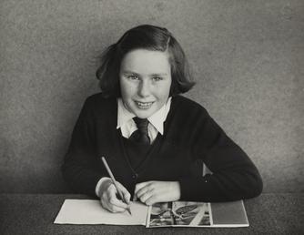 Mary Boulton, holding pencil at desk at Ramsey…