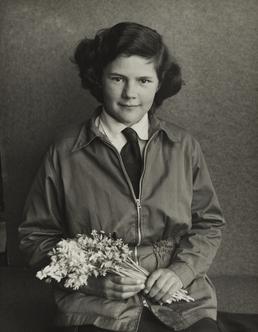 Judith Mawdsley, sitting holding a bunch of flowers…