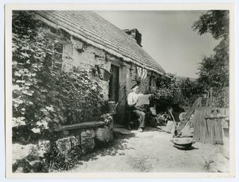 John Kinnish ('Old Pete') sitting outside his cottage…