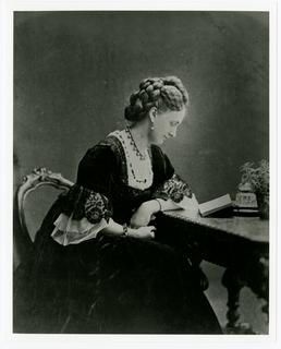 Lady Loch - seated at a desk reading