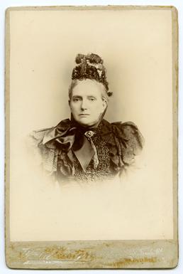 Studio portrait of lady with ribbon tied hat