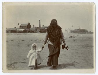 Lady with child on beach, Ramsey