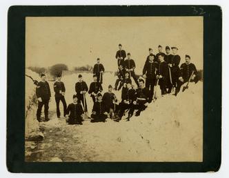 Military personnel posing whilst clearing snow